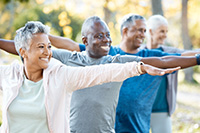 Stretching, yoga and senior people in park for muscle health, workout and training with retirement community. Pilates, exercise and happy elderly friends, group or women and men for fitness in nature.